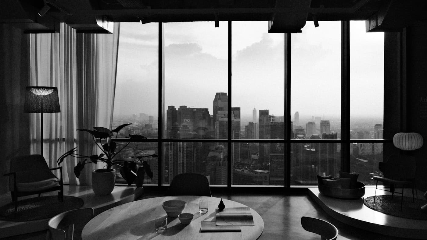 Penthouse interior with a floor-to-ceiling city skyline view